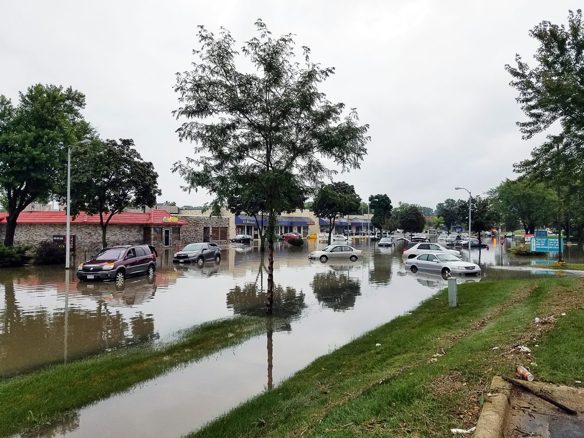 Flooded parking lot with submerged cars after heavy rain